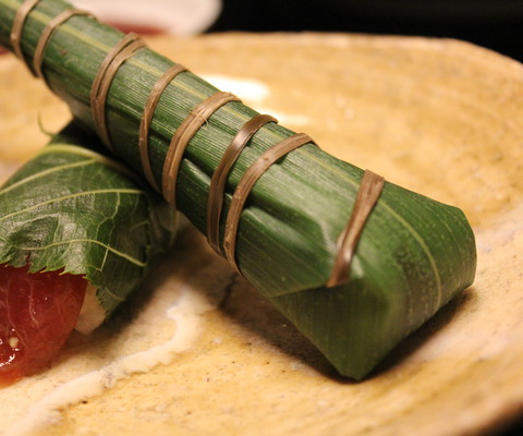 Sushi wrapped in persimmon leaves.